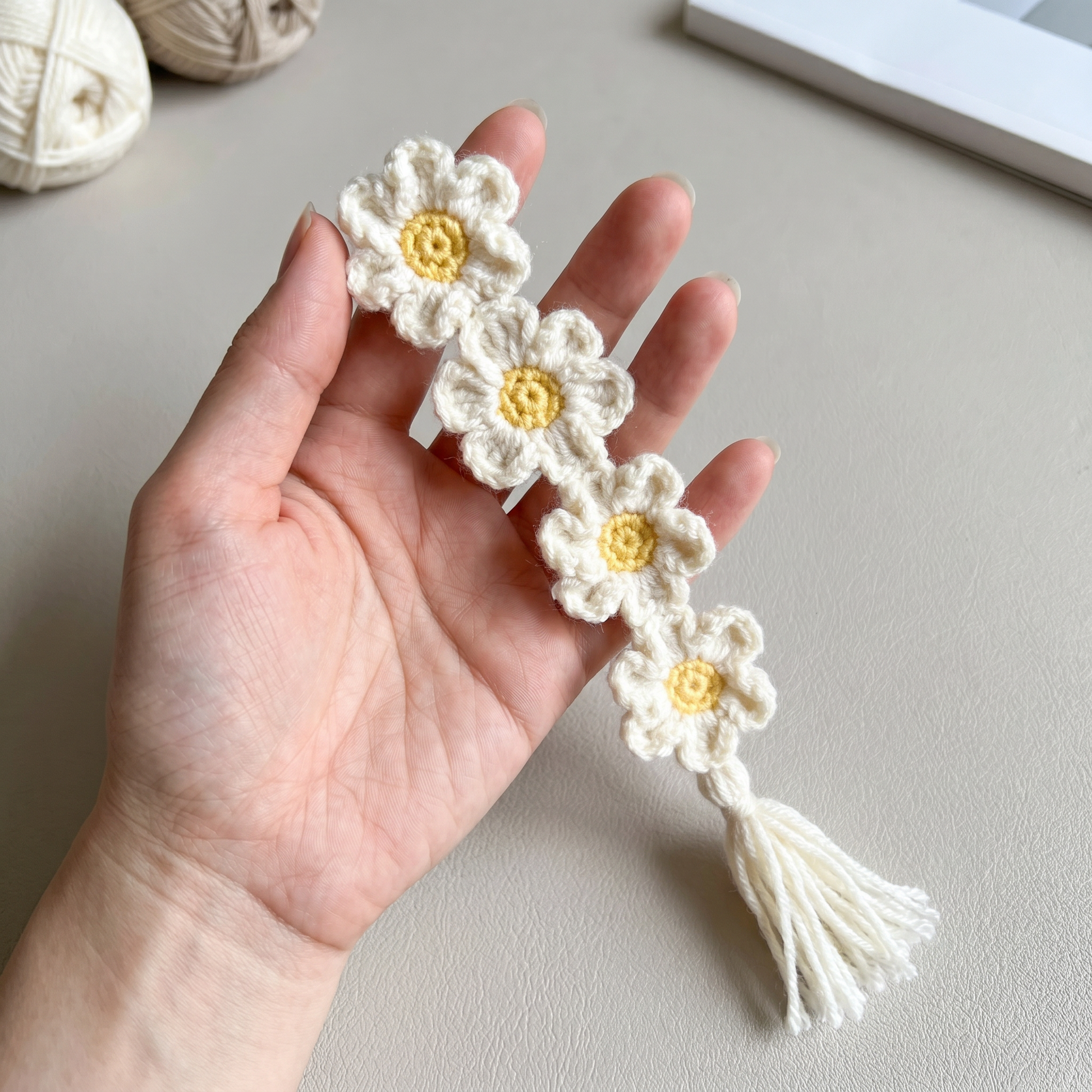 Daisy Chain Crochet Bookmark held in hand to show scale