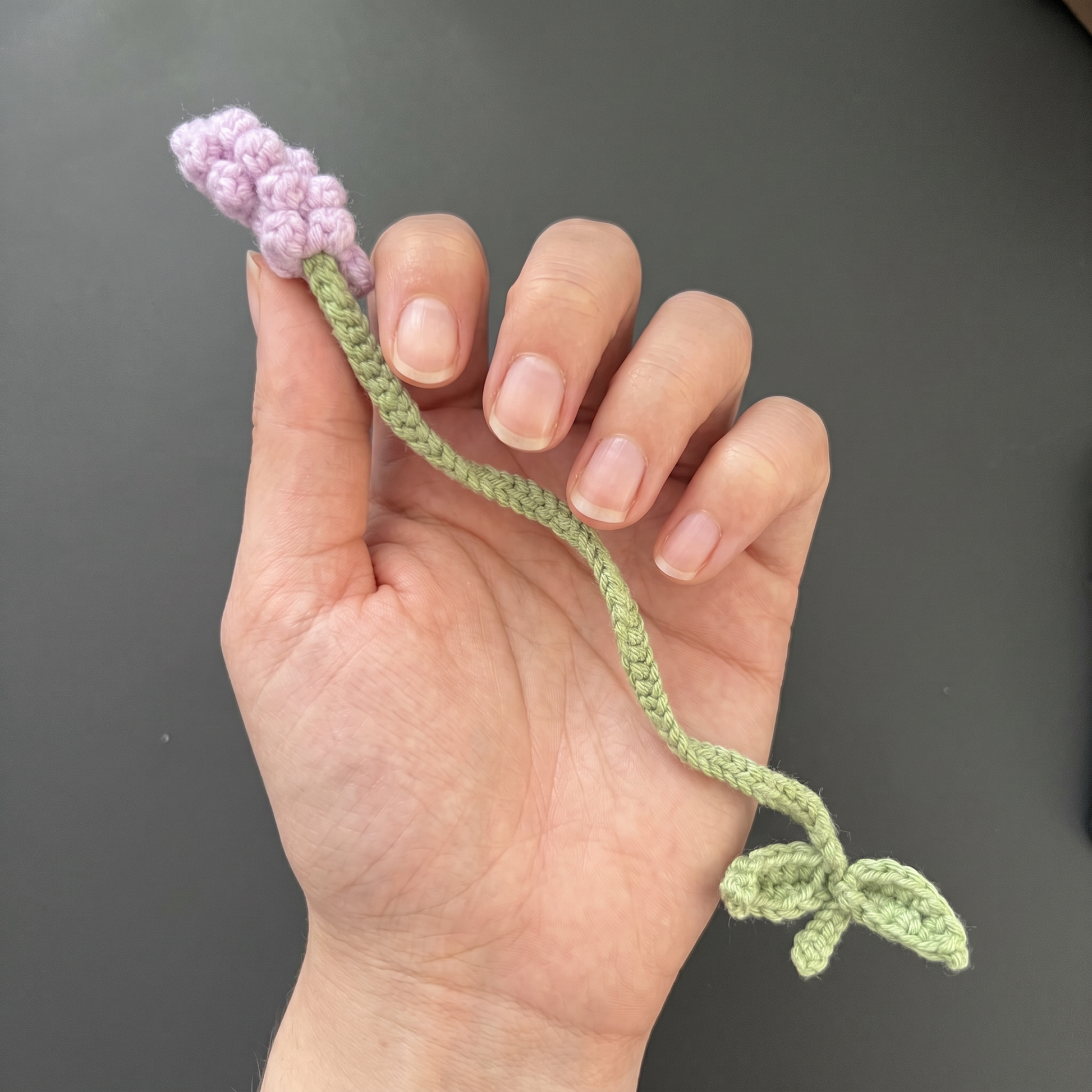 Baby Lavender Crochet Bookmark held in hand to show scale
