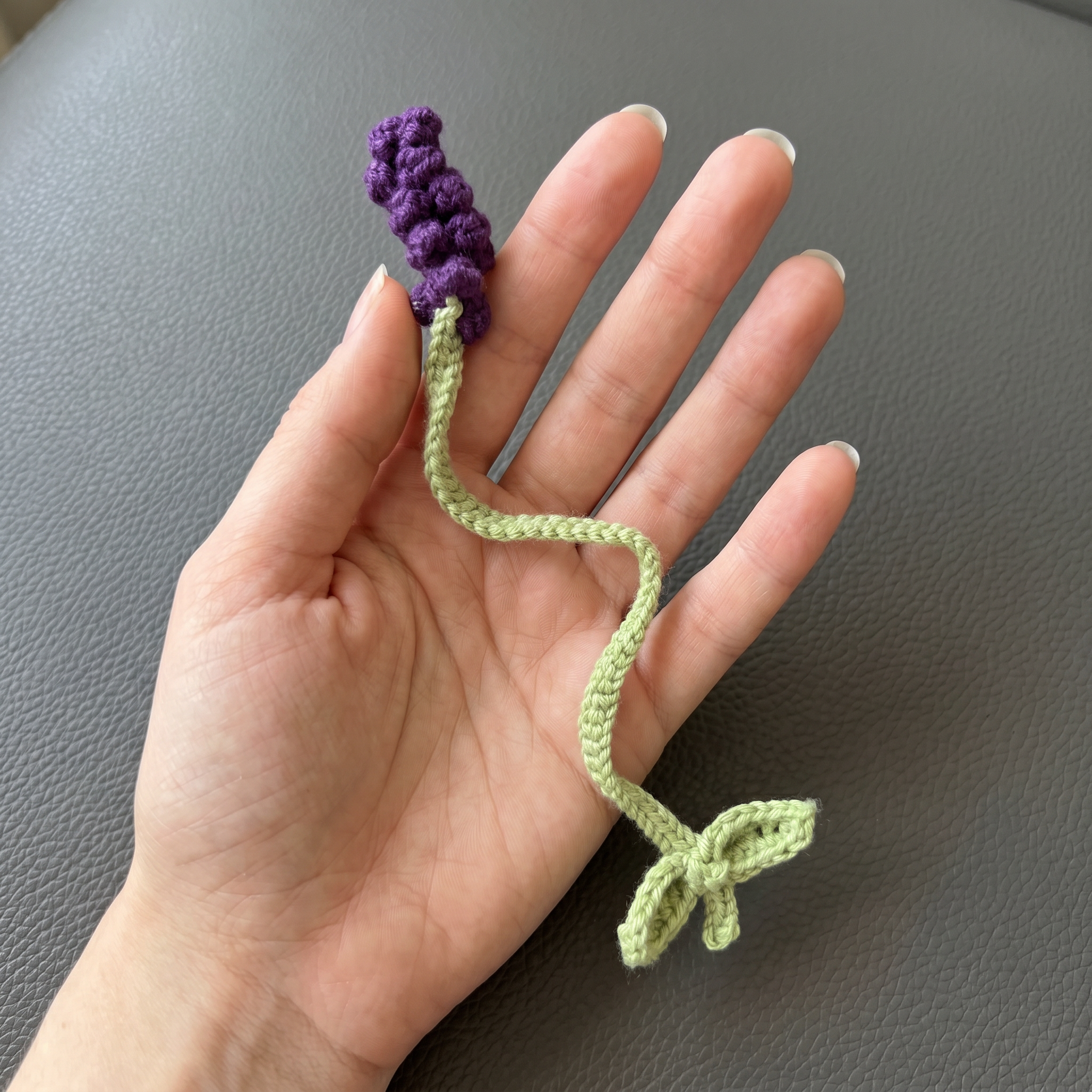Deep Purple Lavender Crochet Bookmark held in hand to show scale