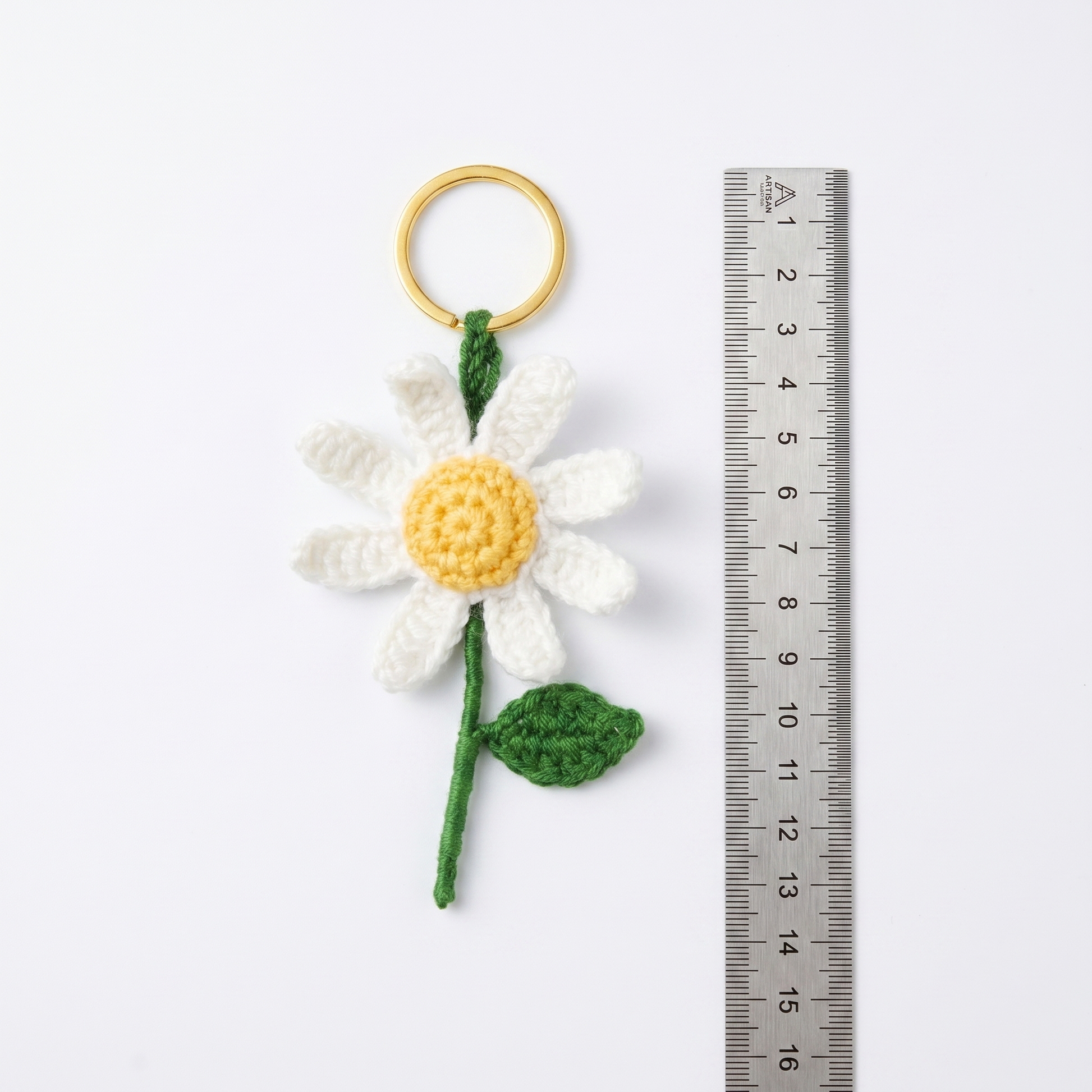 White Daisy Crochet Keychain with a size reference