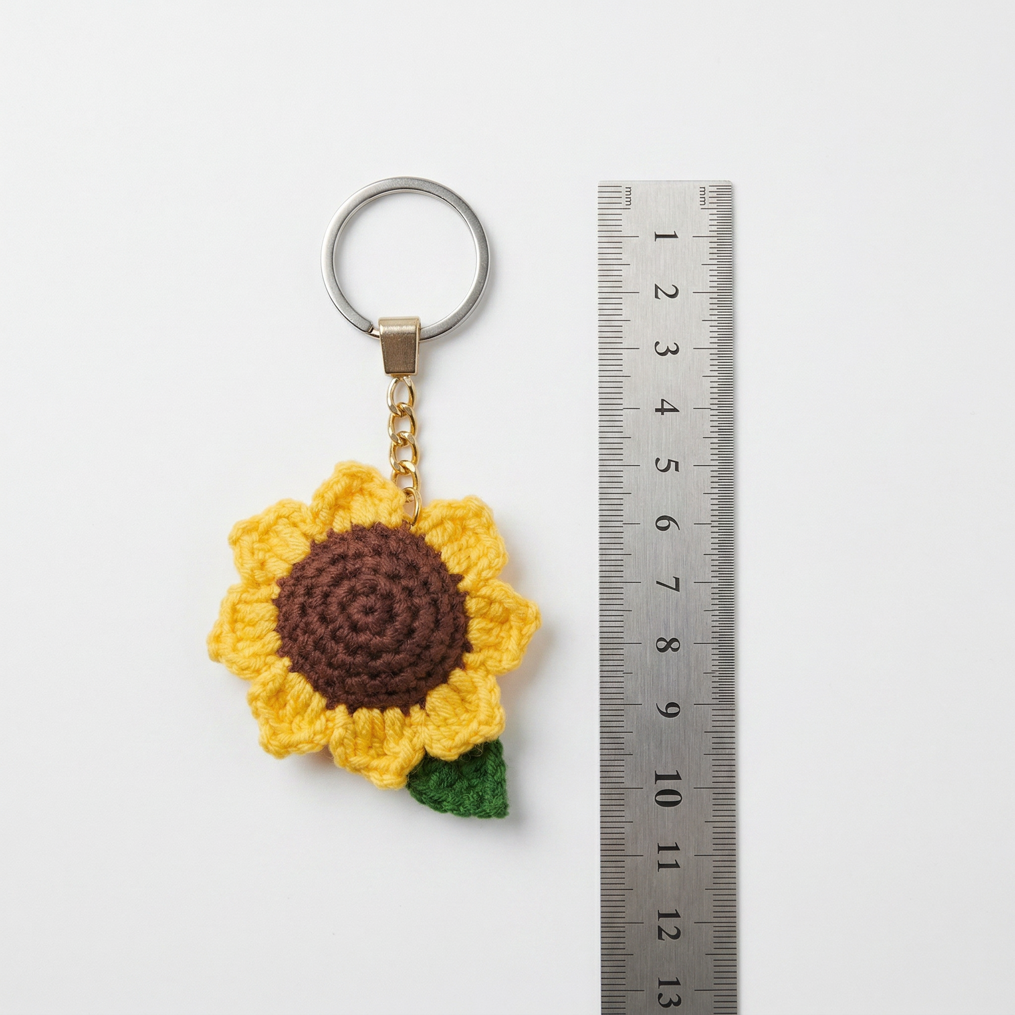 Sunflower Crochet Keychain with a size reference