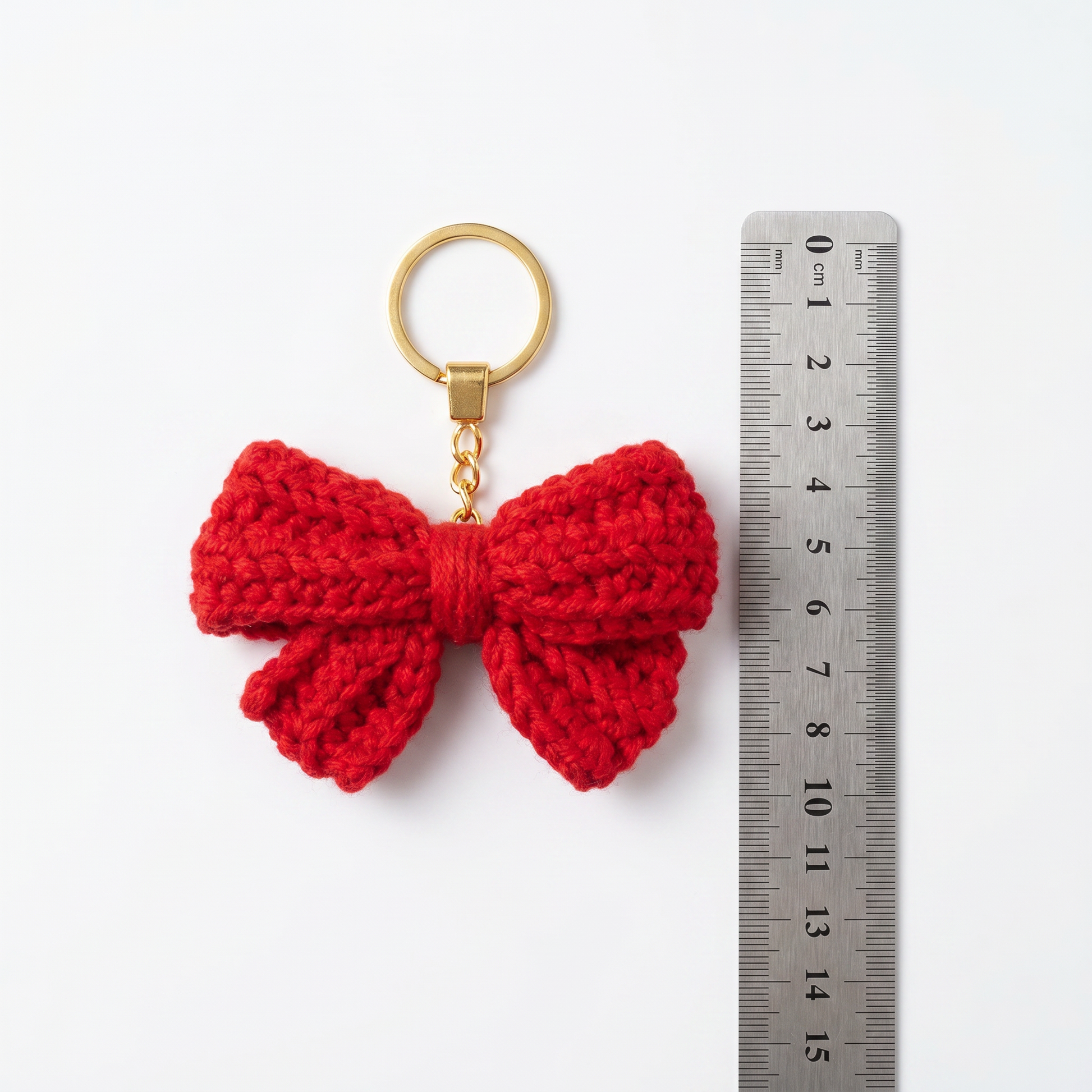 Red Bow Crochet Keychain with a size reference