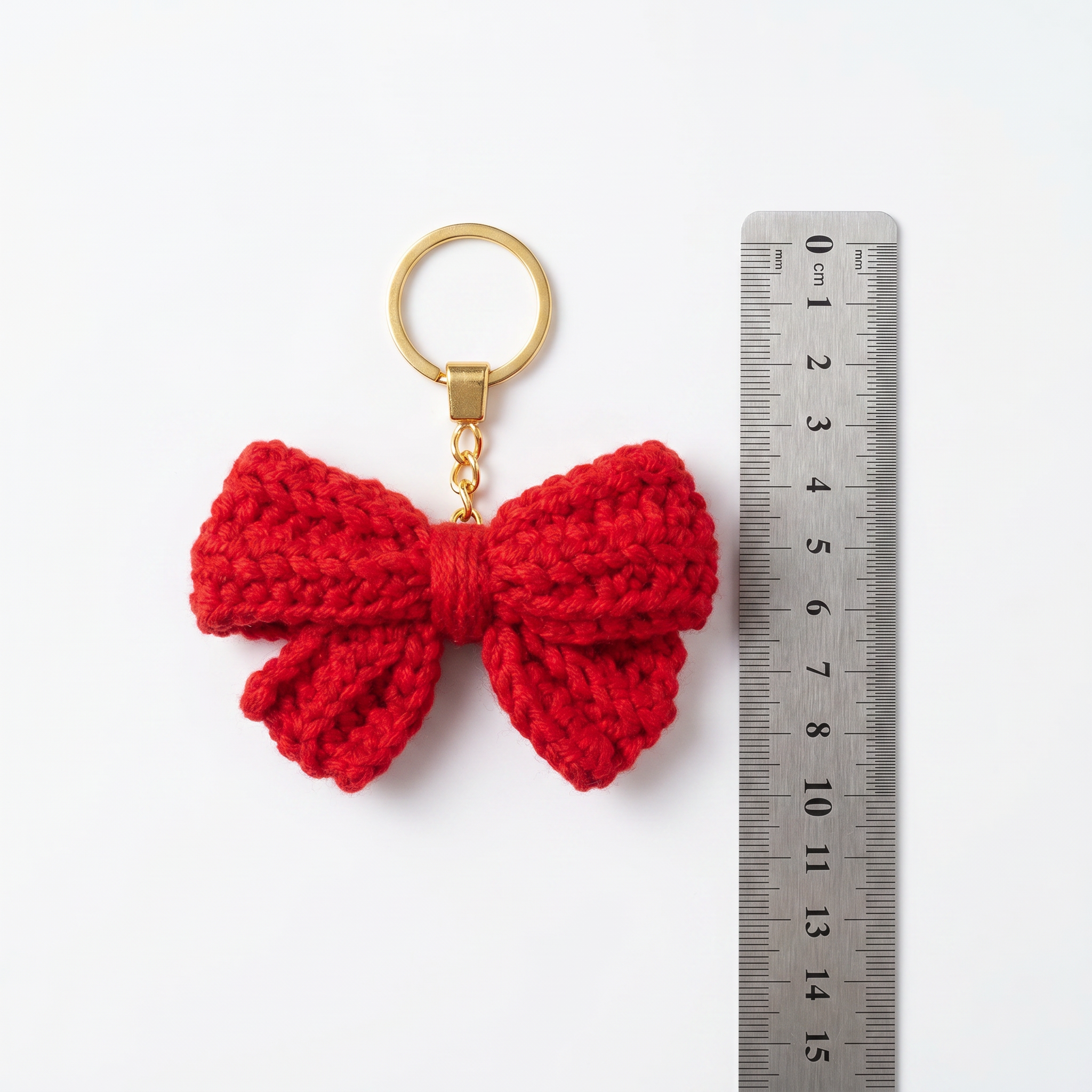 Red Bow Crochet Keychain with a size reference
