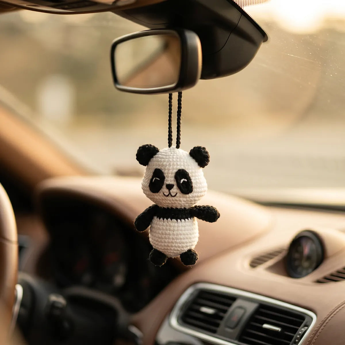 BerryBow Little Panda crochet car charm in a lifestyle setting